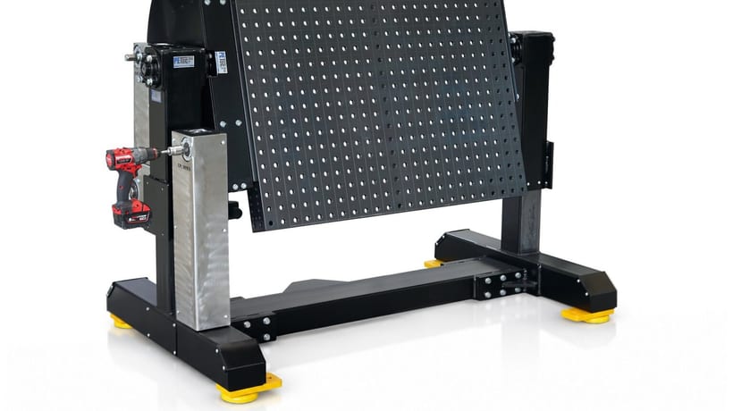 Height-adjustable assembly table in a manufacturing environment, a worker assembling a component in an ergonomic working posture